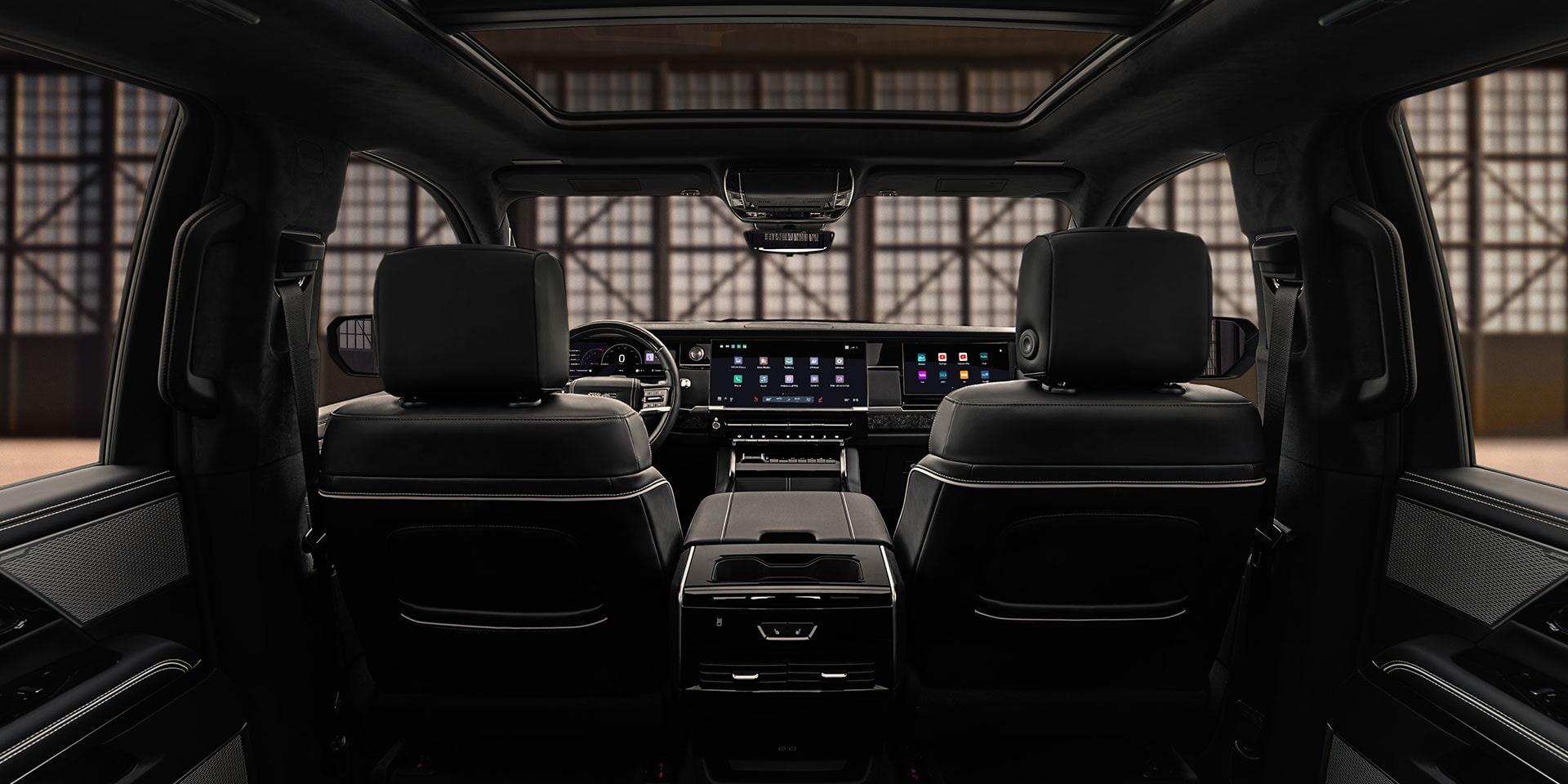 The Spacious Interior Cabin of the GMC Sierra 1500 Viewed From the Rear Seats Showing the Dashboard and Displays