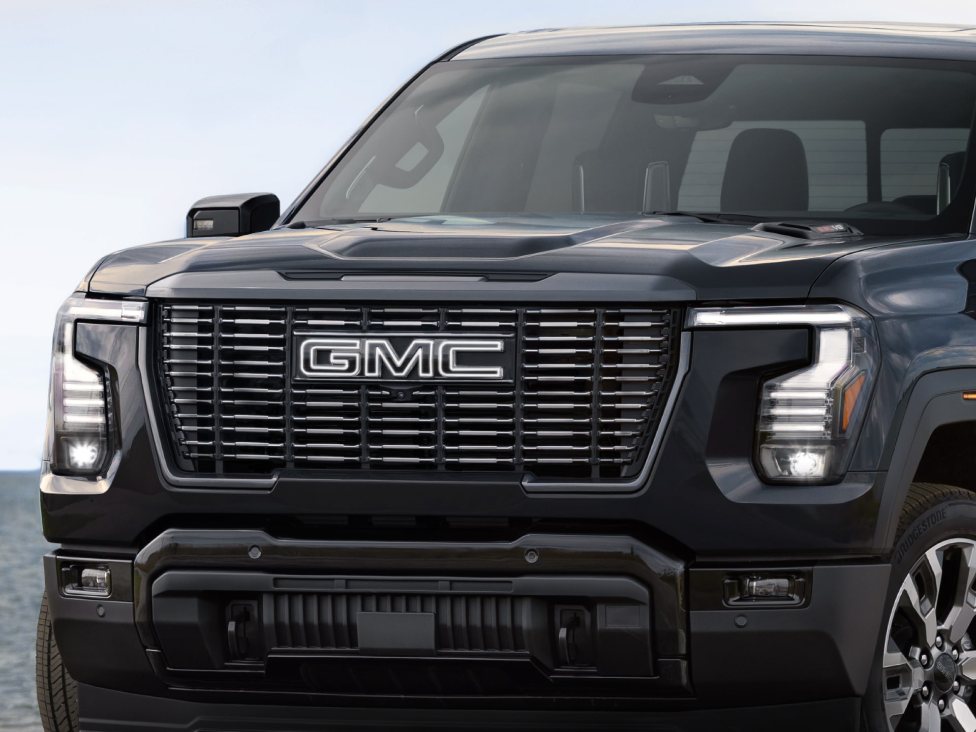 Close-up of the grille and headlights on a 2027 GMC Sierra 1500 Denali Ultimate
