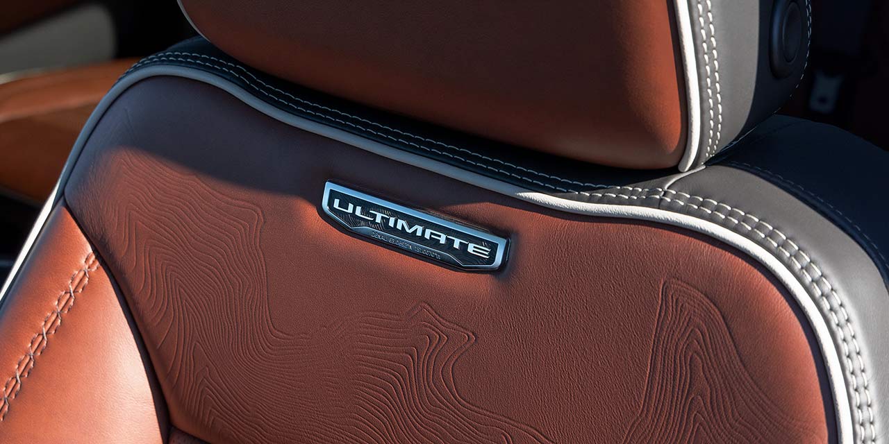 A Close-Up of a Brown Leather GMC Sierra HD Ultimate Trim Seat with a Topographic Pattern