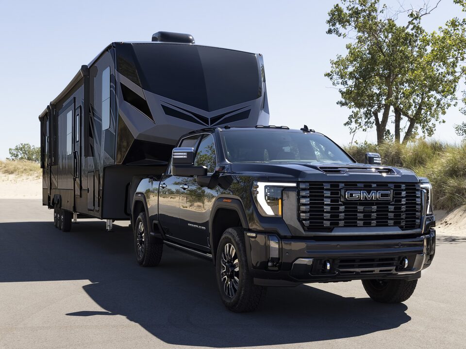 A Front View of the GMC Sierra HD in Black Parked with a Trailer