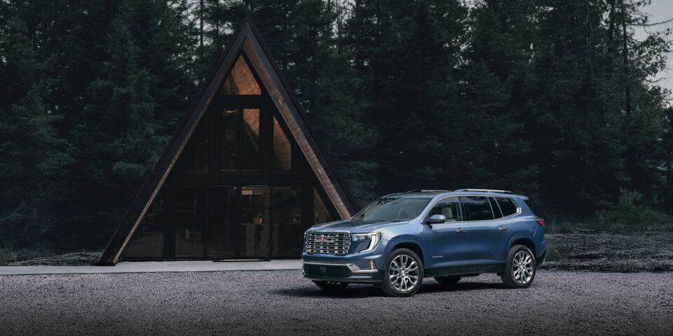 A Parked 2024 GMC Acadia Denali in Front of a Cabin