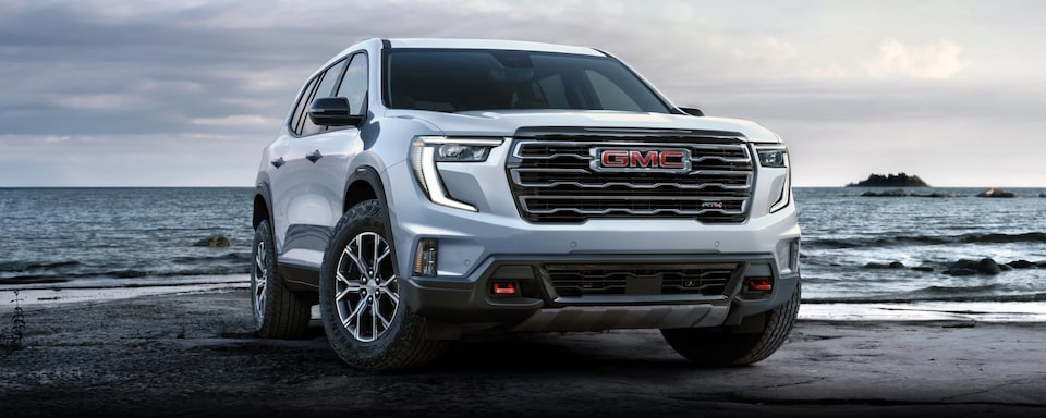 Close-up Front Three-Quarters View of a 2024 GMC Acadia AT4 SUV with Text Overlay "Exterior"