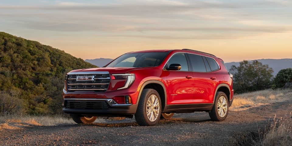 Wide Front Three-Quarters View of a 2024 GMC Acadia Elevation SUV Parked at Sunset