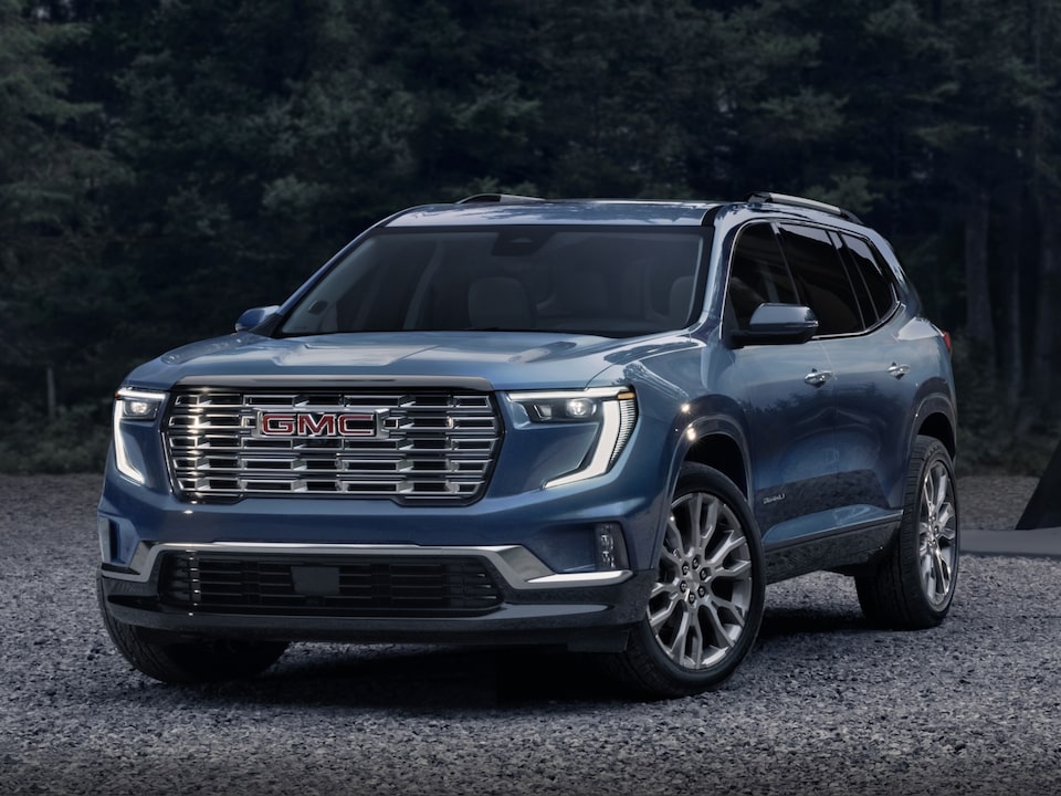 Front Three-Quarters View of a 2024 GMC Acadia Denali Parked on a Gravel Path