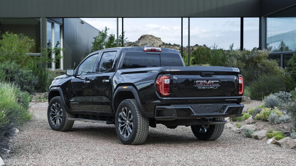 The New Black GMC Canyon AT4X Parked Off-Road Near a Building