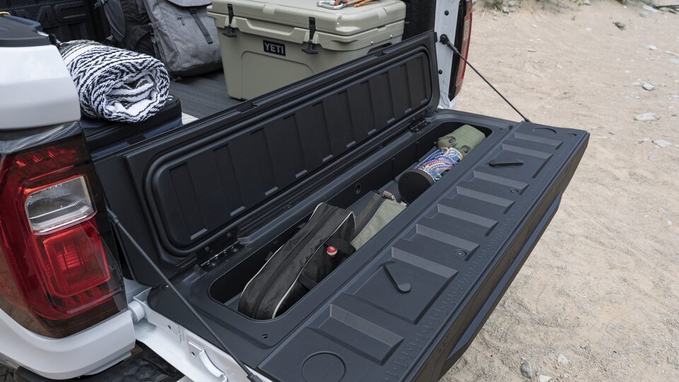 Closeup on the Rear Power Liftgate Pulled Down with Cargo in the Bed of the New GMC Canyon AT4X