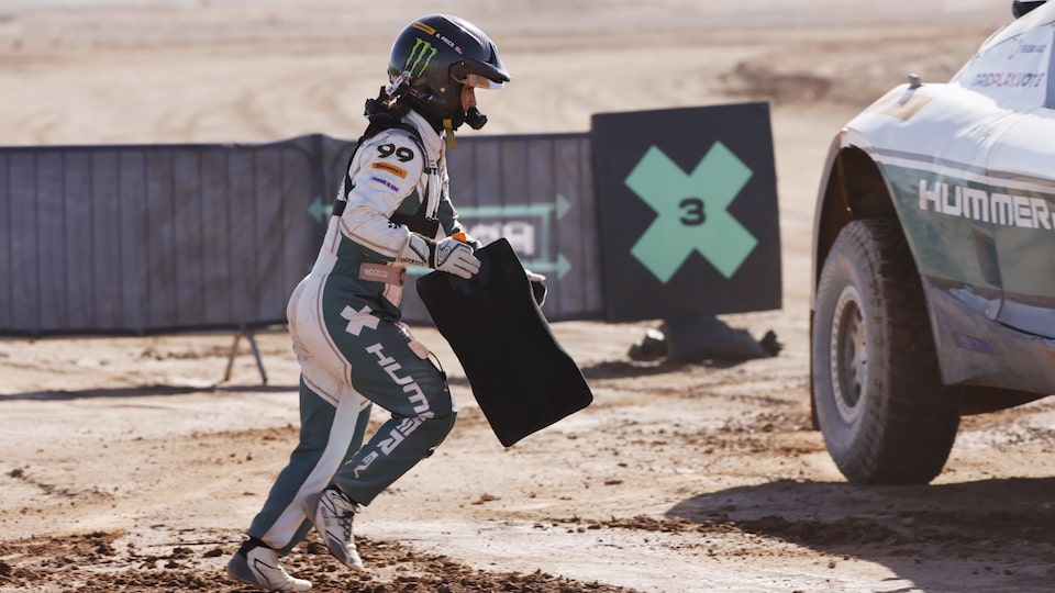 A Shot of a Racer Wearing a Helmet and Rushing Towards a Vehicle