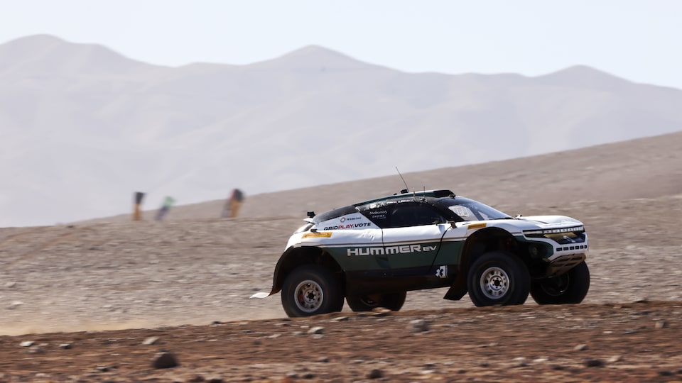 Side Profile View of a Race Car Driving Across the Desert