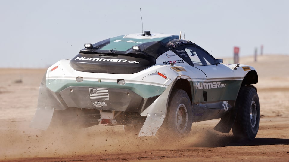 Rear Three-Quarters View of a Race Car Driving Through the Desert