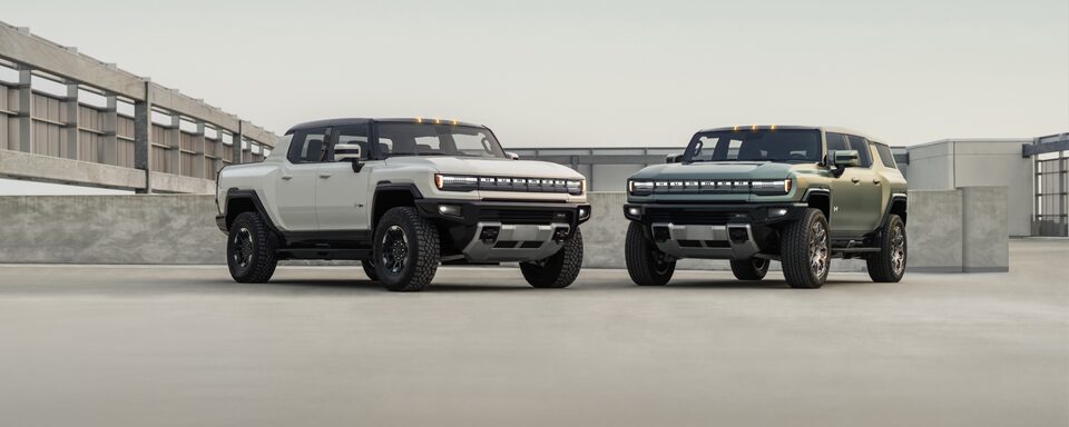 Two GMC Hummer EVs in a parking lot