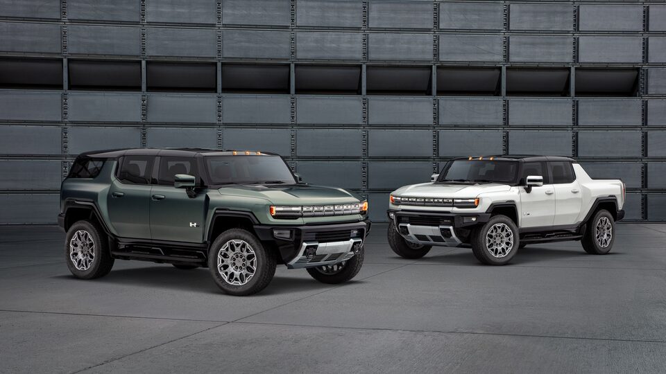 GMC HUMMER EV electric SUV and electric truck parked by building