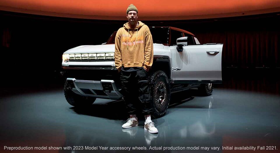 John Geiger standing with the GMC Hummer EV electric truck
