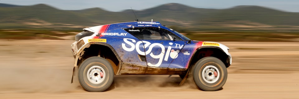 Side View of The No. 99 SEGI TV GMC HUMMER EV.R Racing in Sardinia