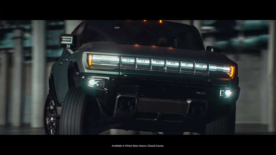 GMC Hummer EV SUV driving at night
