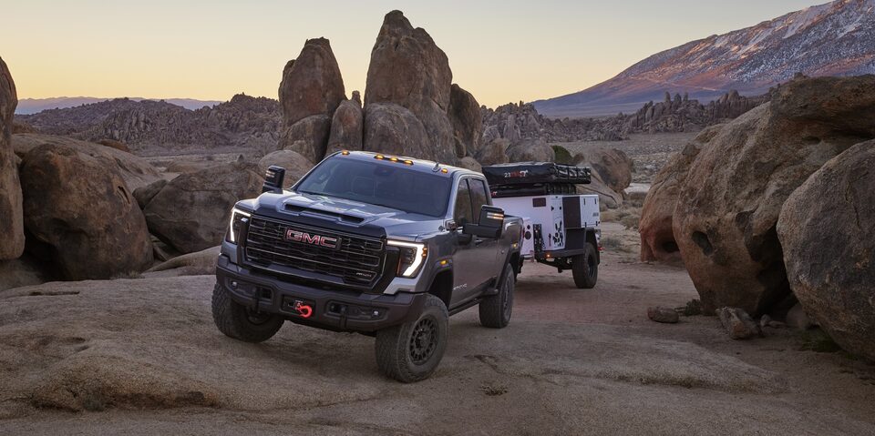 A GMC Sierra HD AT4X Towing a Trailer Off-road