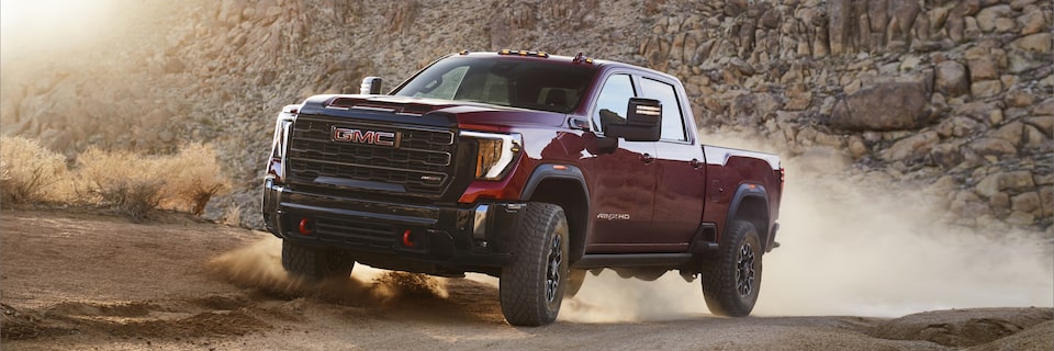 The New GMC Sierra HD AT4X Driving Off-road Kicking Up Dirt