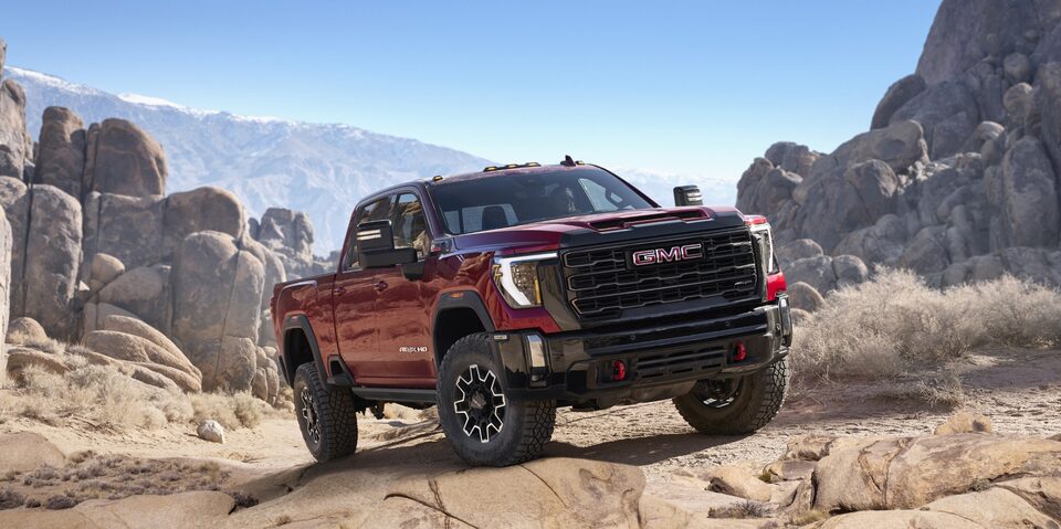 The Powerful New GMC Sierra HD AT4X Driving Uphill on a Rock