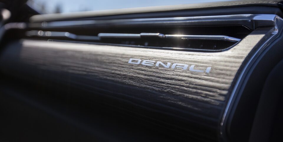 Closeup on the Denali Nameplate on the Passenger Dashboard of the GMC Sierra EV Denali