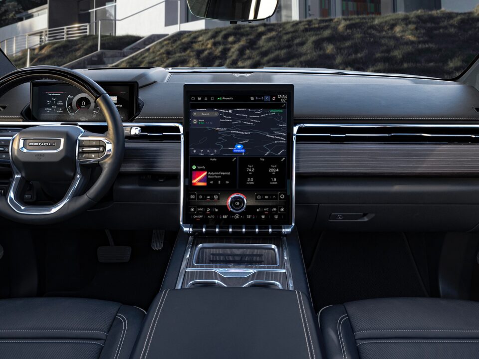 A Passenger Side View of the Interior of the GMC Sierra EV with the Steering Wheel and Infotainment System