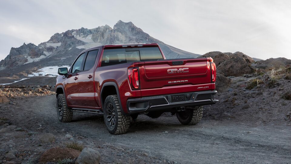 A Rear View of the GMC Sierra LD Driving Off-Road