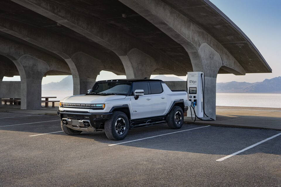 The Hummer EV Charging at a Station with a Mountain Backdrop