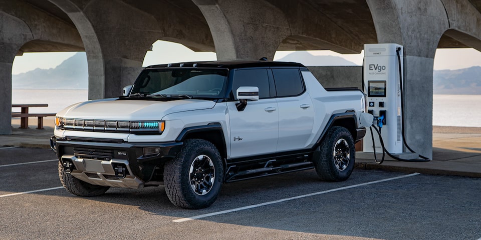 The Hummer EV SUV at a Charging Station with a Mountain Backdrop 