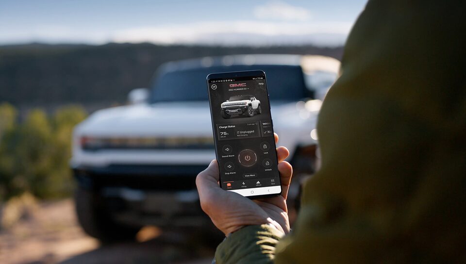 A Hummer EV Owner Using the myGMC Mobile App to Adjust Settings