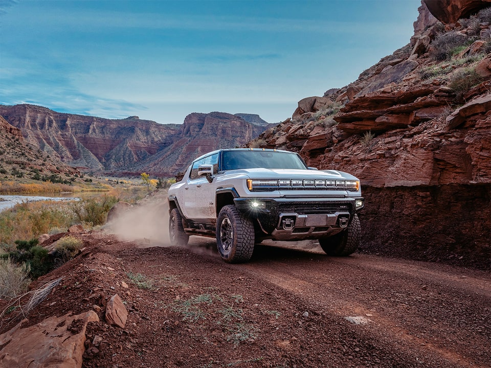 The Hummer EV Pickup Kicking Up Dust on an Open Desert Roadway 
