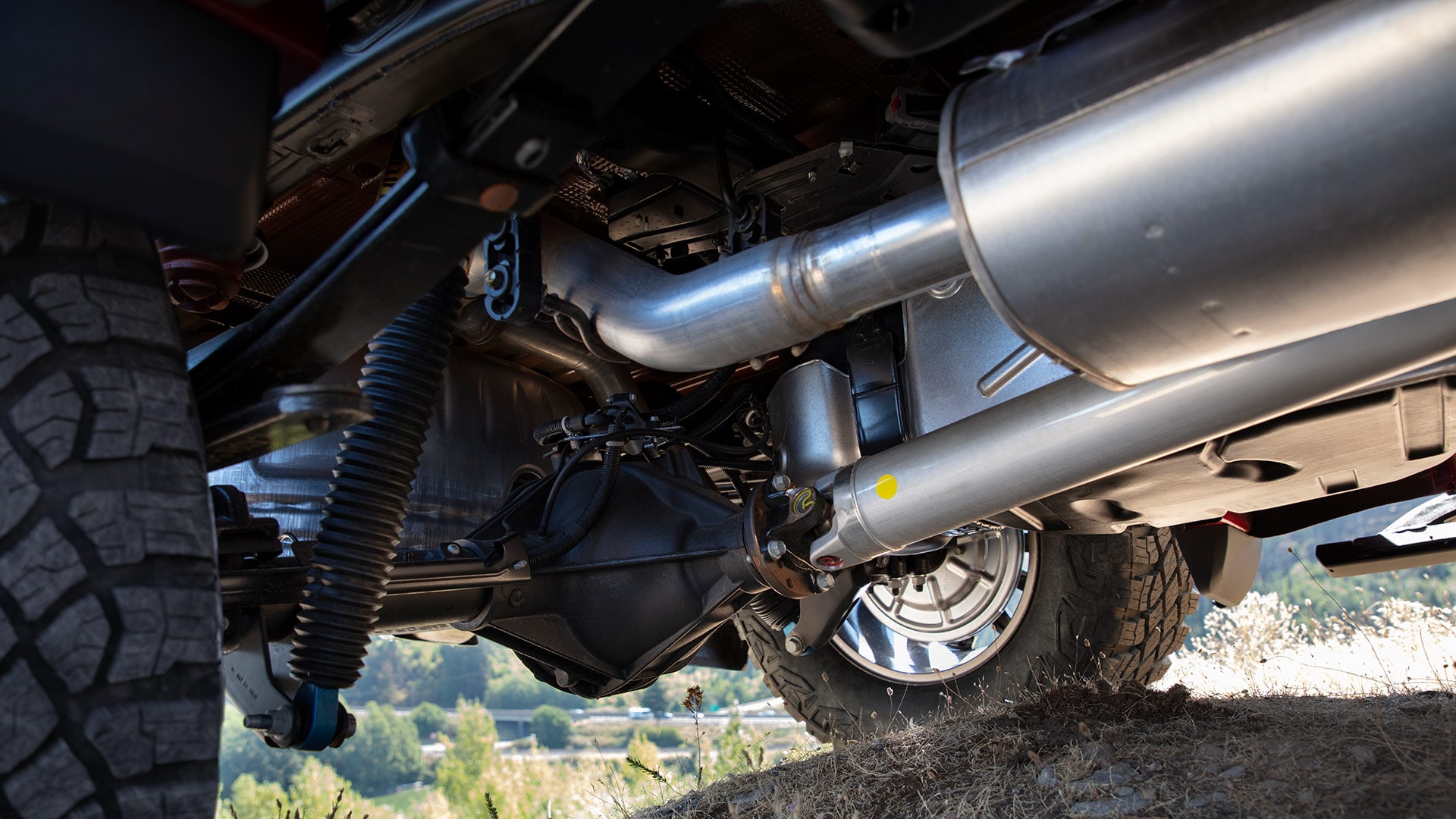 An Undercarriage View of the GMC Sierra 1500 Displaying the Trucks Rear Suspension and Exhaust System