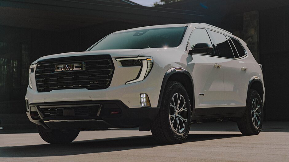 A Parked White 2024 GMC Acadia Parked in a Driveway