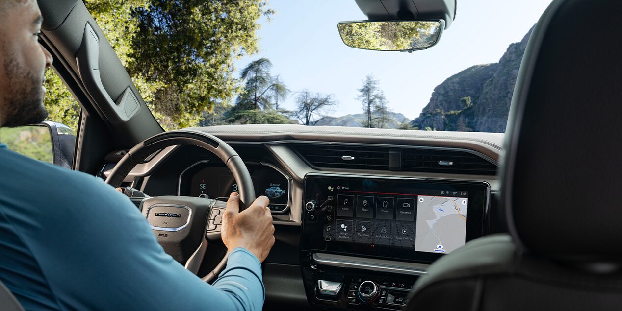 Over the Shoulder View of a Man Driving his GMC Vehicle