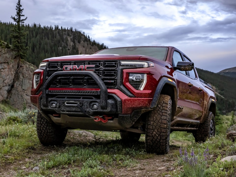 The New GMC Canyon AT4X Driving Off-Road On Grass up a Hill