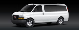 A White GMC Savana Passenger Van Is Parked From a Front Three-Quarters Angle On a Dark Background