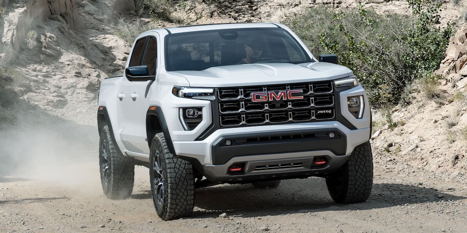 The White GMC Canyon Driving Off-Road on a Dirt Trail