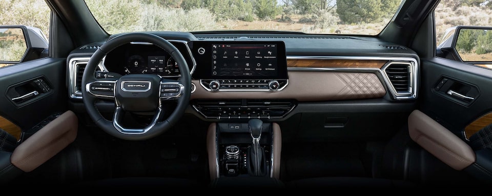The Front Interior with the Steering Wheel and Infotainment System on the GMC Canyon