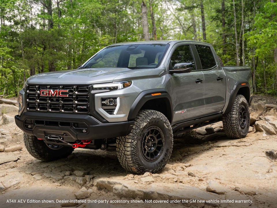 Gray GMC 2024 Canyon AT4 rock climbing in forrest