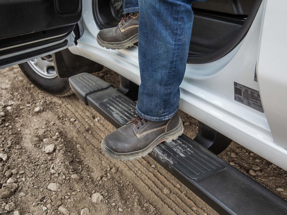 Close-Up of a Person's Boots as They Step Out of a GMC Sierra HD Truck