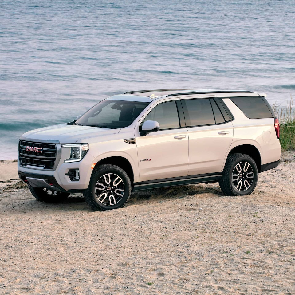 2024 GMC Yukon AT4 Parked on the Sand by a Body of Water