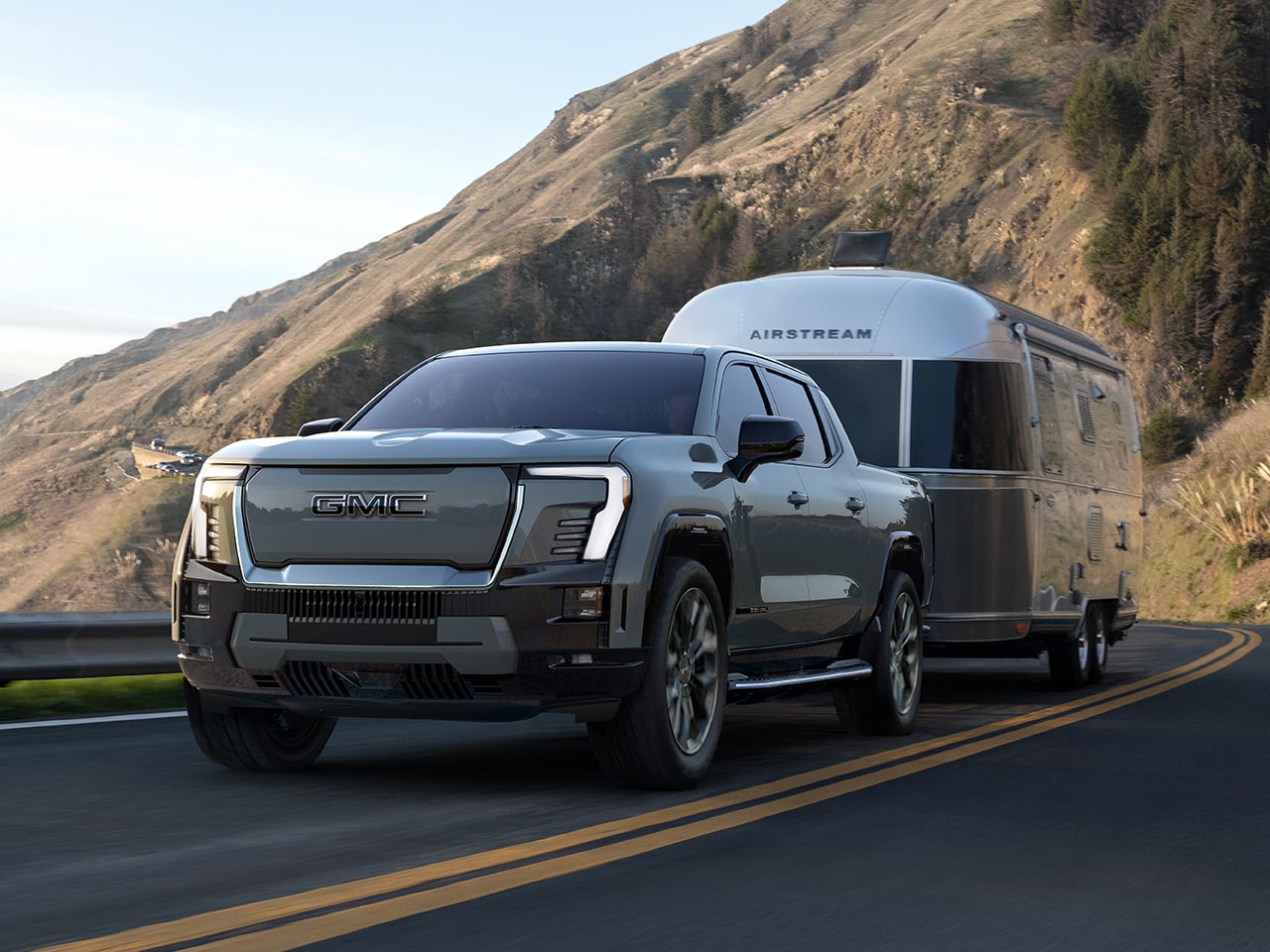 The GMC Sierra EV Pickup Truck Driving Down the Open Road Towing an Airstream