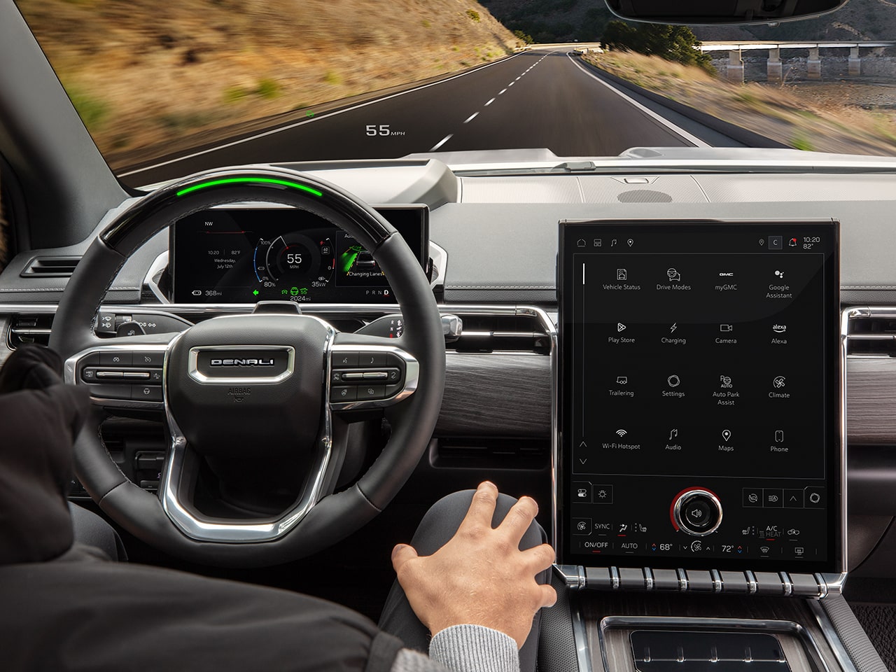 Over the Shoulder View of the GMC Sierra EV Pickup Truck Steering Wheel and Infotainment System